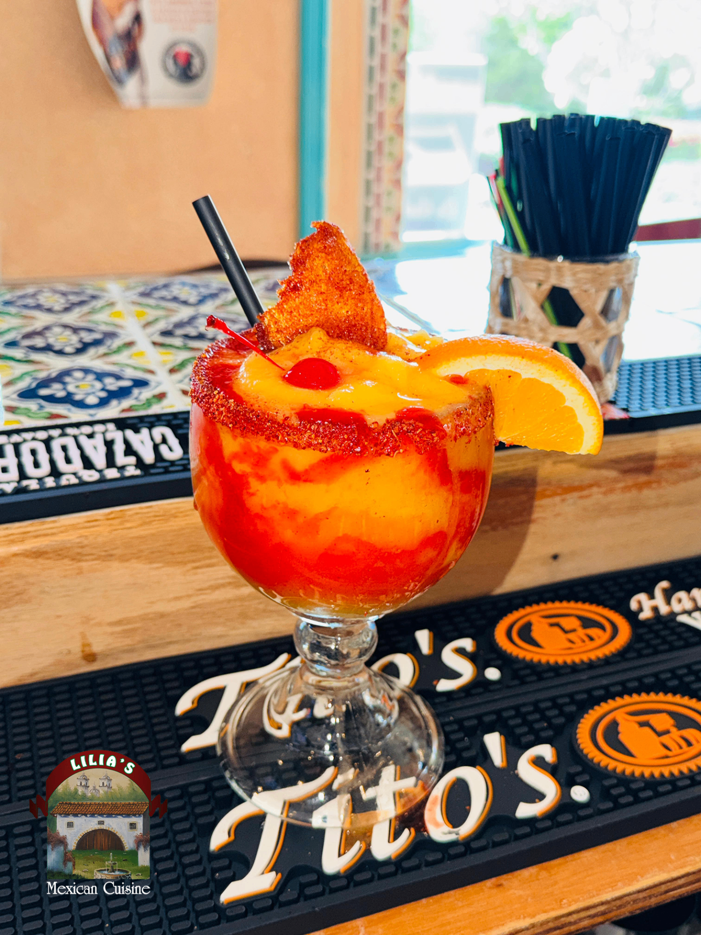 Frozen margarita with tajin rim ready for Happy Hour at Lilia's